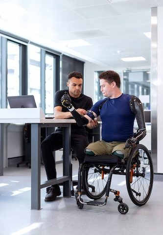 a man in a wheelchair with robotic prosthetic arms - Do not let anything stand in your way