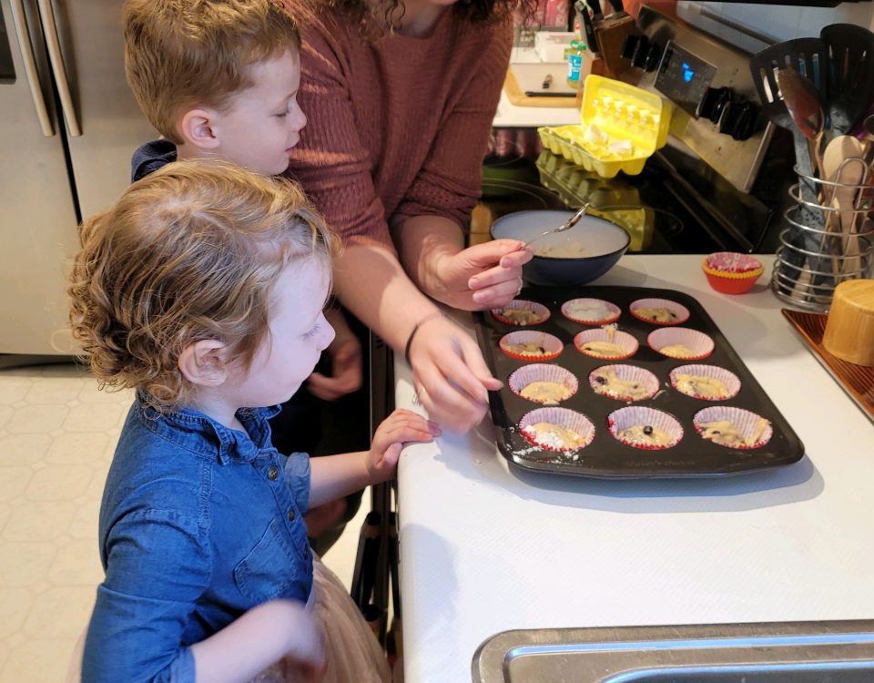 denise baking cookies in muffin tins with her son and daughter - superhero mom