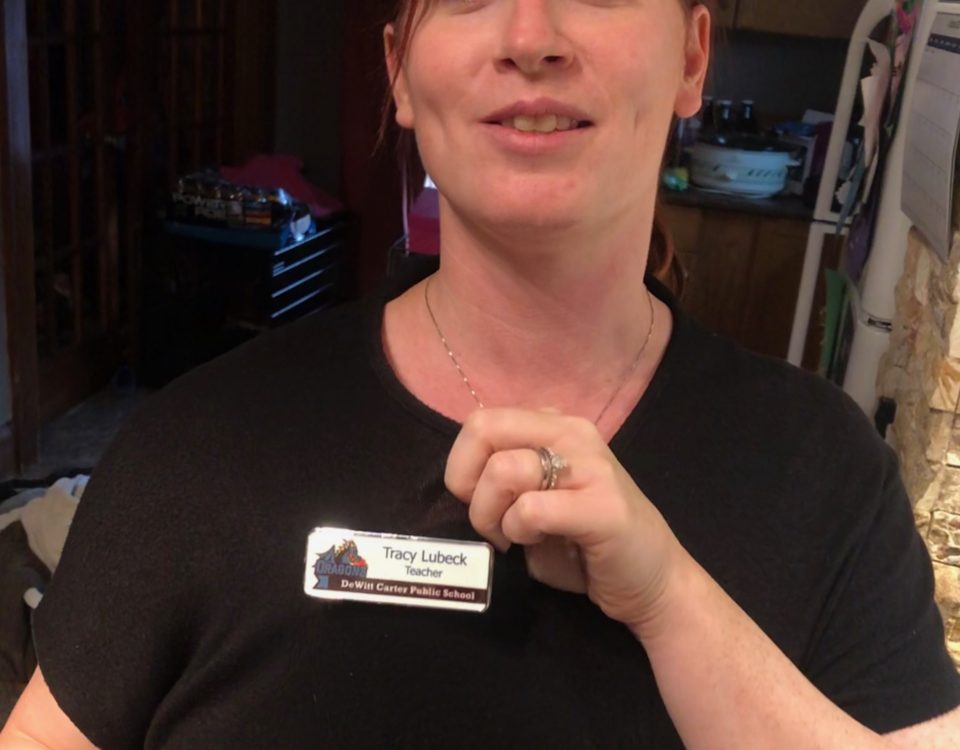 tracy lubeck wearing her teacher badge for dewitt carter public school