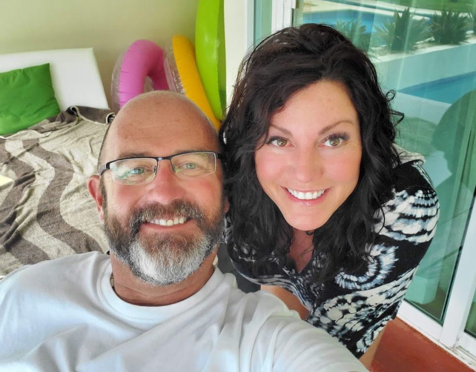 justin and kimberly tate on the porch with inter tubes behind them