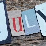 JULY word composed of letters. It's time for a new month. Concept for business - July holidays blog post