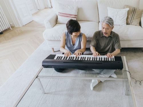 couple playing piano - National Couples Day - August holidays blog