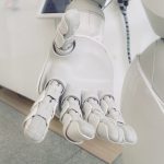 White AI robot hands lending a helping hand