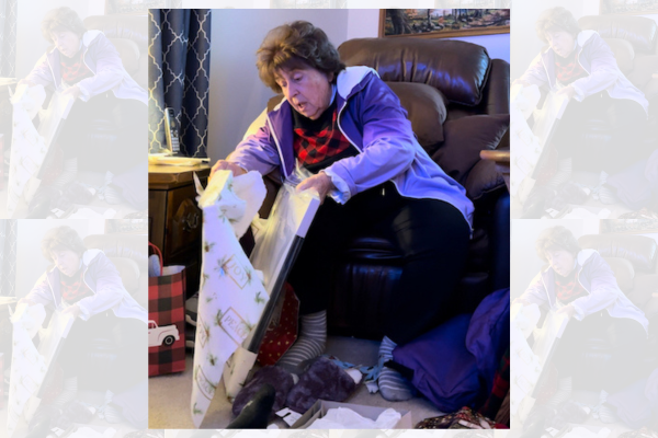 Grandma opening her FrontPage Story Christmas gift