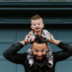 dad holding young son on his shoulders - a great and happy Father's Day