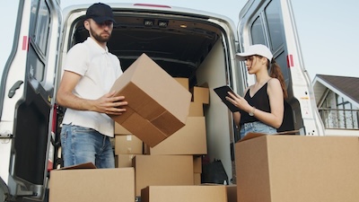 professional movers handling boxes in a truck