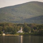 Lakefront view of church-type building in New Hampshire