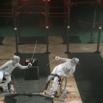 Paralympics athletes competing in wheelchair fencing