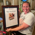 Ashley Potts holding her brown framed personalized story - ANNIVERSARY GIFT blog post