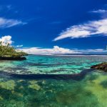 History of Oceania blog post - Beach on Samoa Island - Natural infinity rock pool with palm trees over tropical ocean lagoon