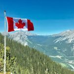 Canadian Flag with a mountain in the background