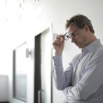 strategies for managing stress blog post - Photo Of Man Holding Black Eyeglasses